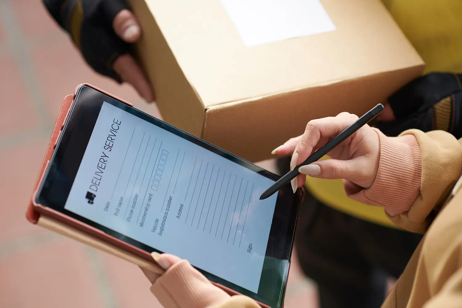 woman signing electronic proof of delivery on tablet