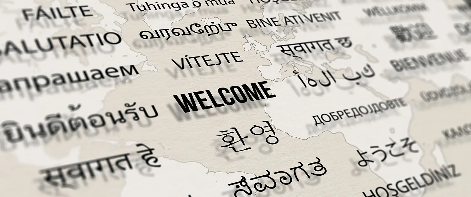 welcome different languages paper with world map background