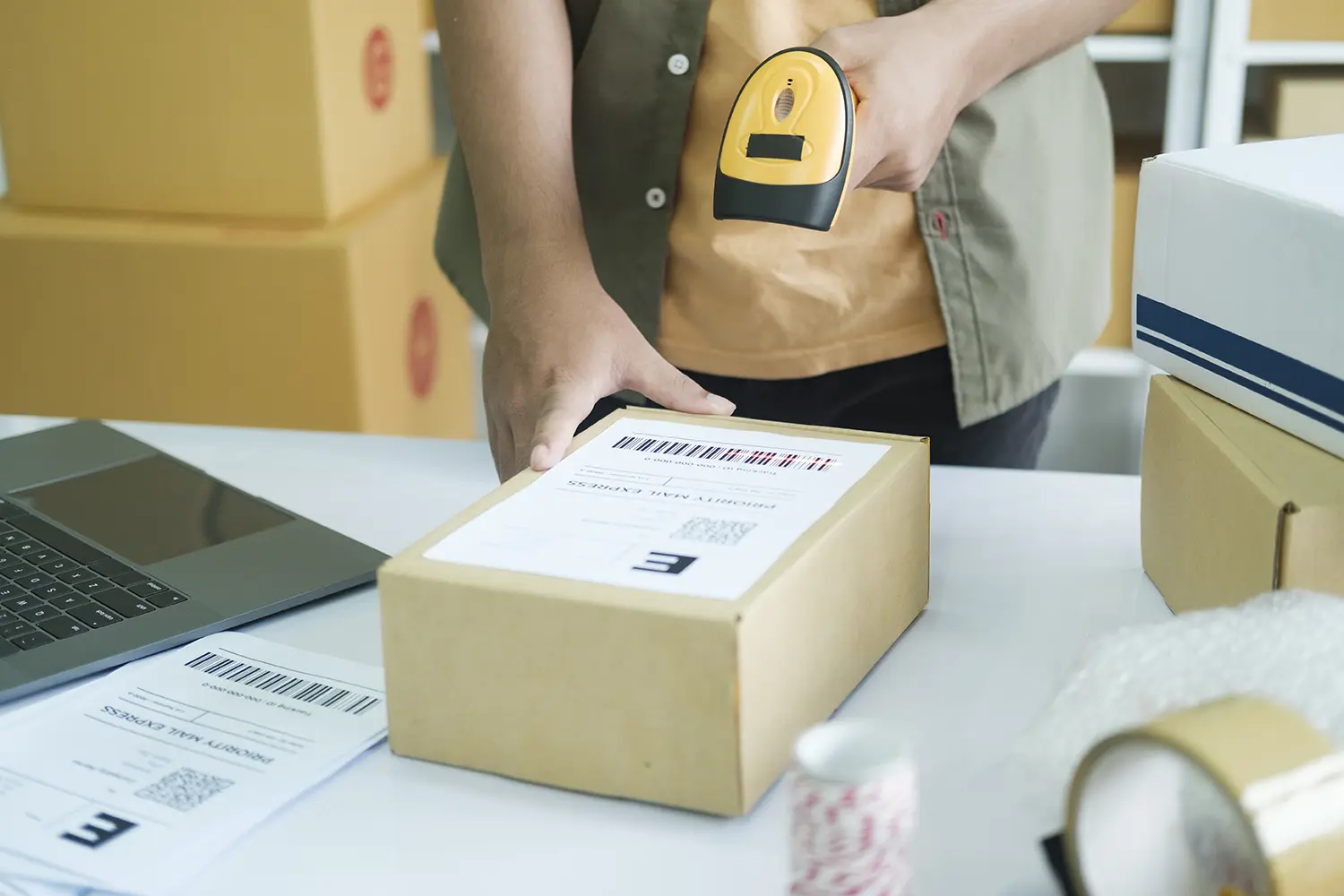 scanning shipping label on parcel for delivery