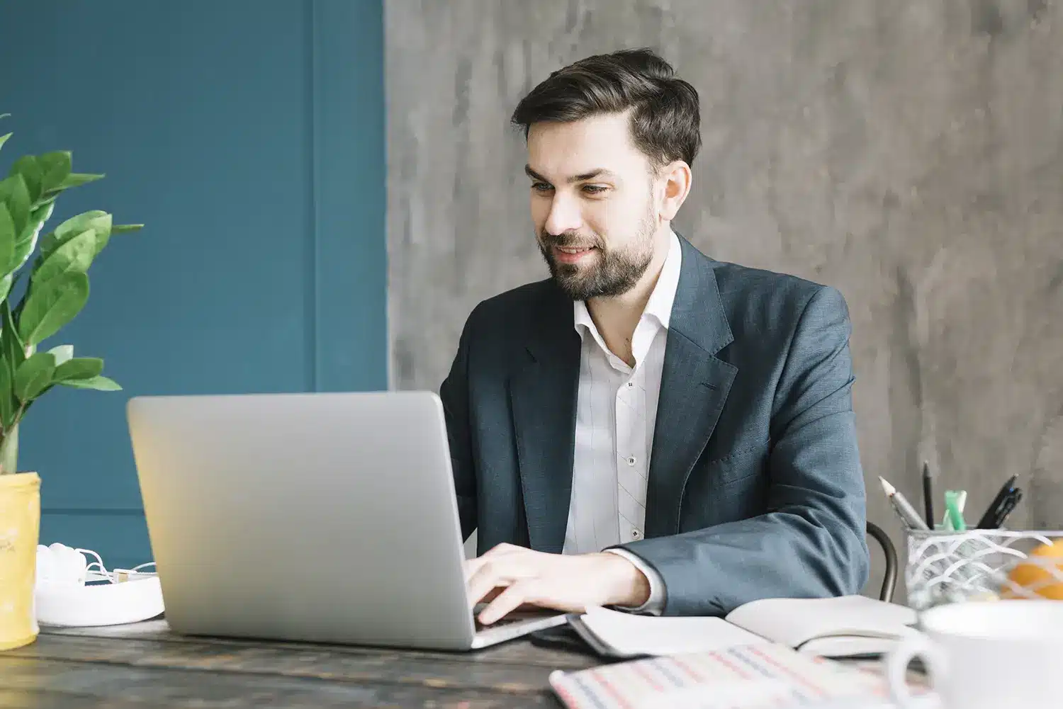 positive businessman using laptop