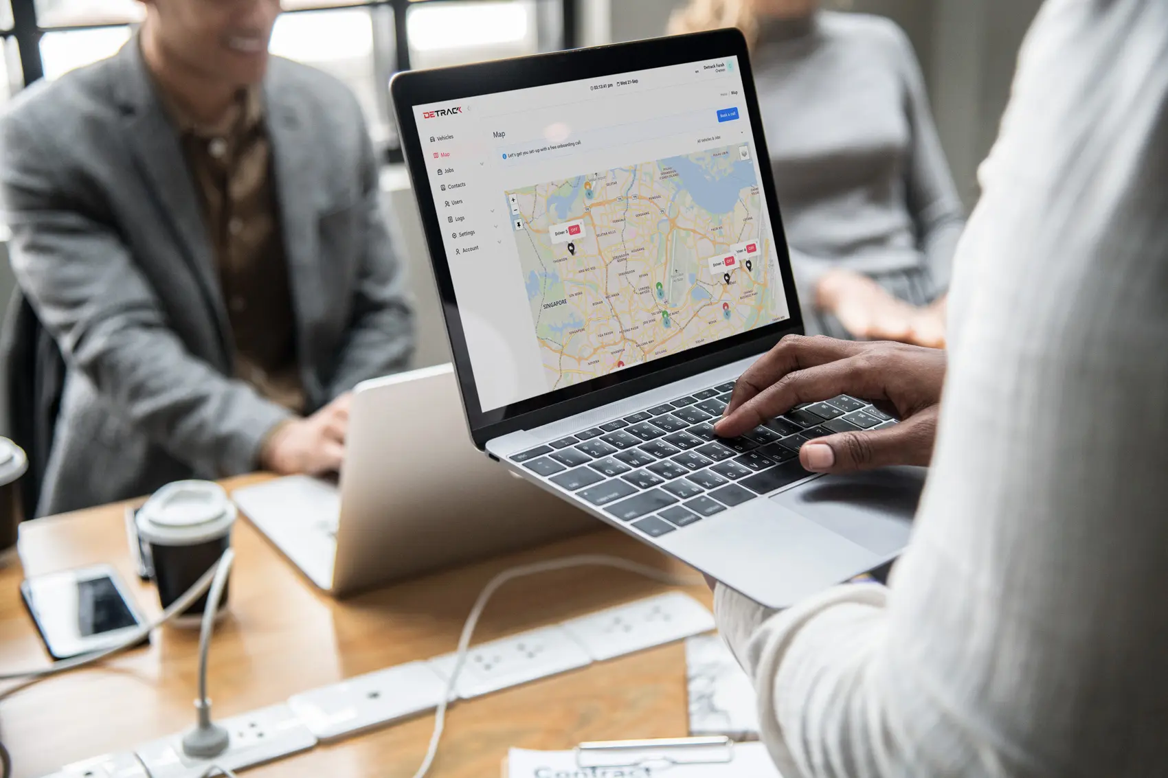 Detrack plan change - man using Detrack tracking widget on laptop